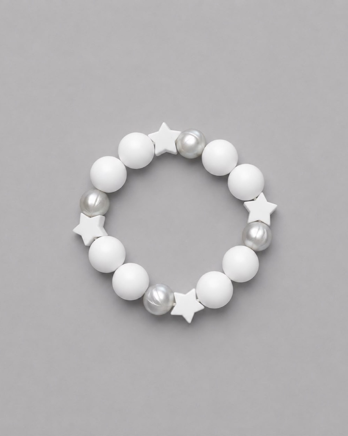 Anneau de dentition Étoile Perle : perles blanc cassé, perles argentées nacrées et quatre étoiles blanches