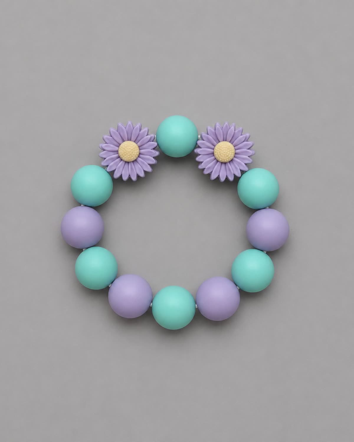 Anneau de dentition Jardin Lilas : perles vert menthe et parme, deux marguerites lilas au cœur jaune